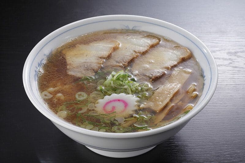 Kitakata ramen with flat wavy noodles in clear soy sauce broth
