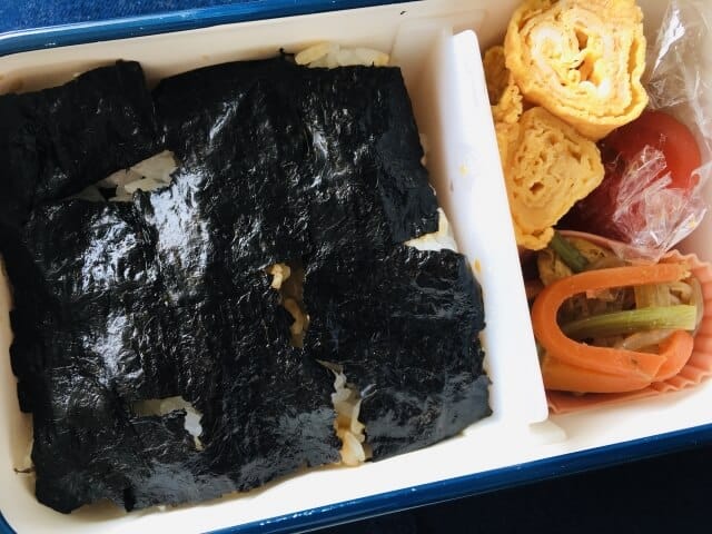 Layered nori rice in a Japanese bento box