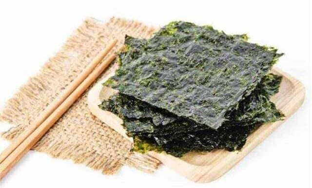 Toasted Seaweed or Nori flat lay on top of a wooden small try