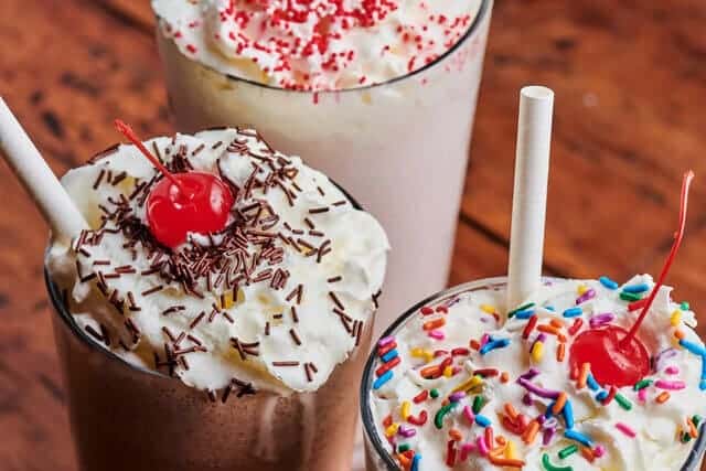 milkshakes with sprinkles and cherry on top
