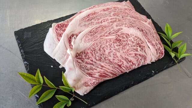 raw wagyu meat on black plate