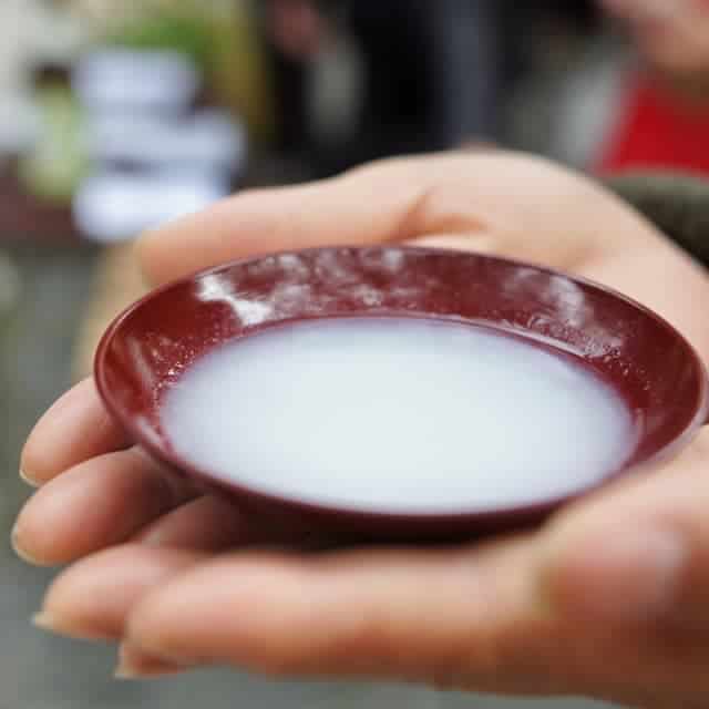 nigori sake holding on hands