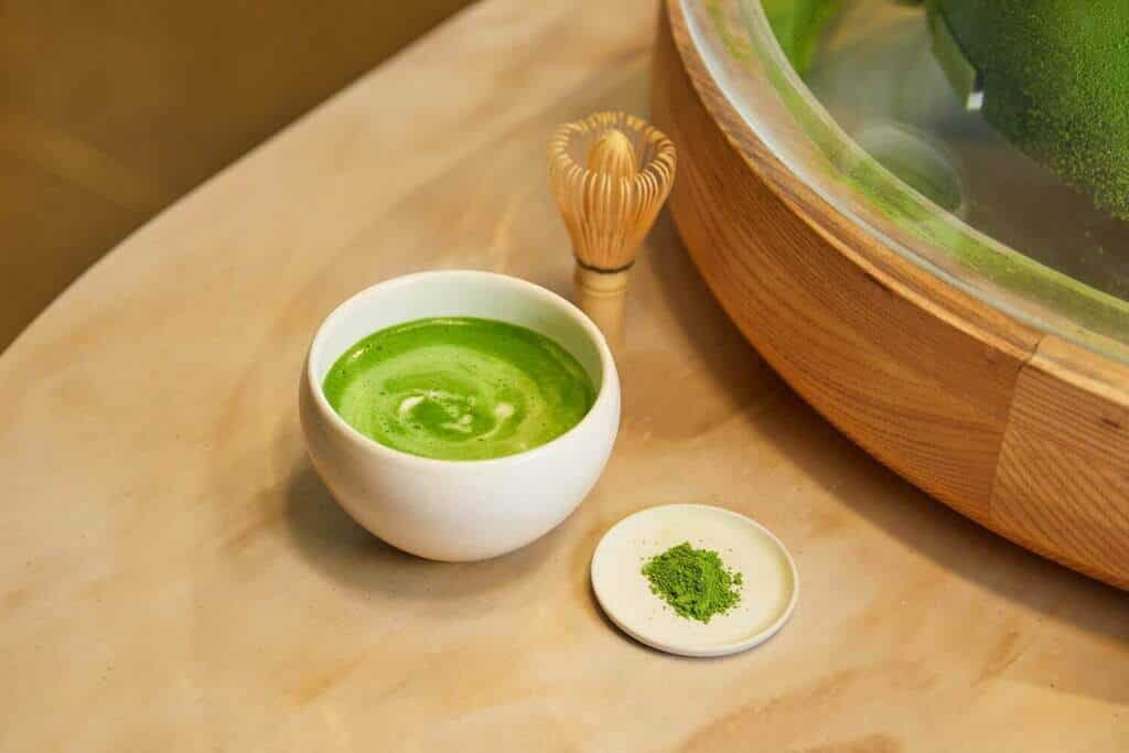 matcha tea on white cup and with chasen