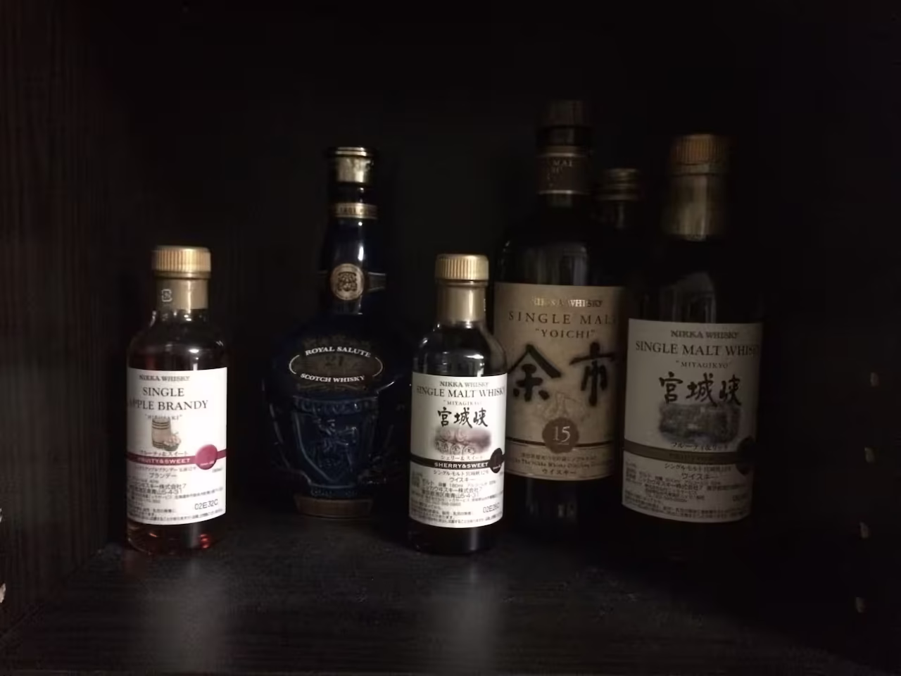 A cabinet filled with bottles of liquor