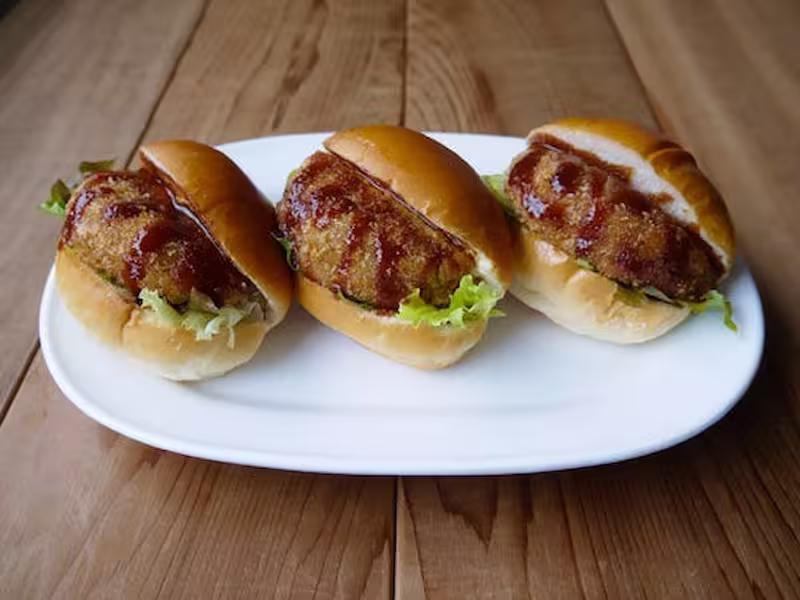 three Crockett breads on white plate