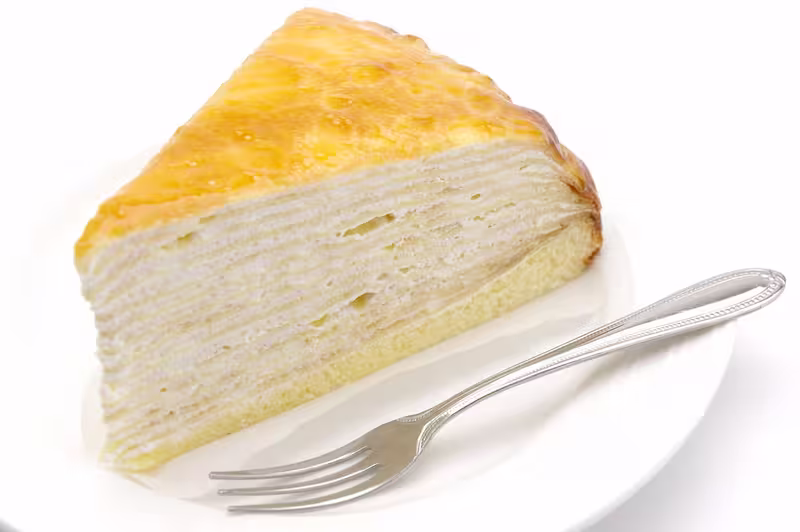 Mille crêpes with spoon at side