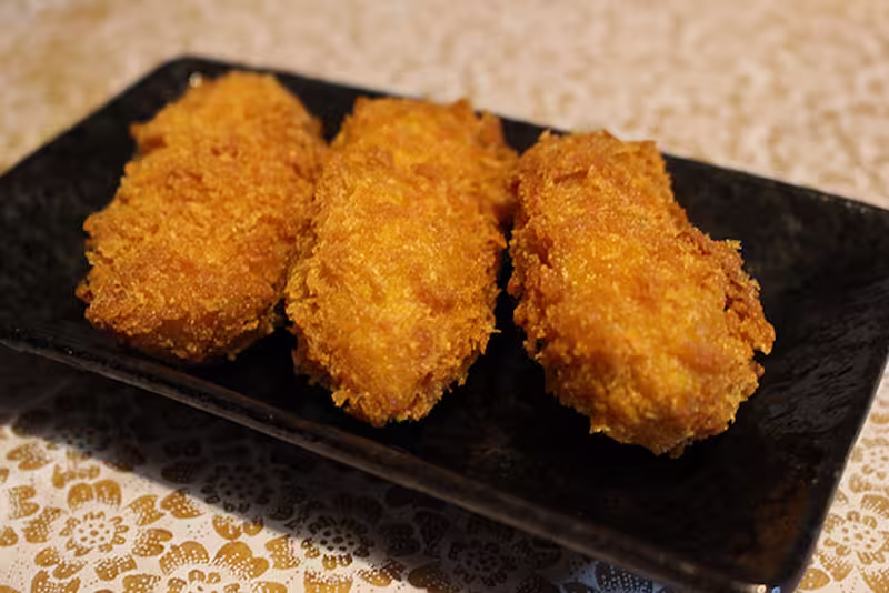 Kaki Fry on black plate