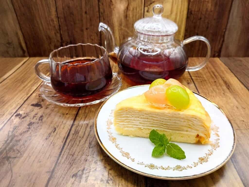 Mille Crepes cake served with tea, showcasing Japanese cafe dessert culture.Japanese-Style Mille Crepe