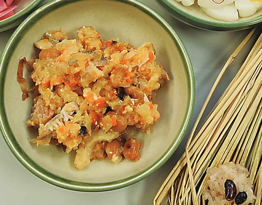 Traditional Japanese sumitsukare served in a green bowl with side dishes.