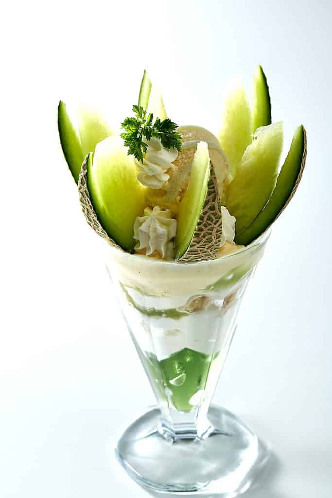 Fresh Ibaraking Melon dessert with whipped cream and mint garnish.