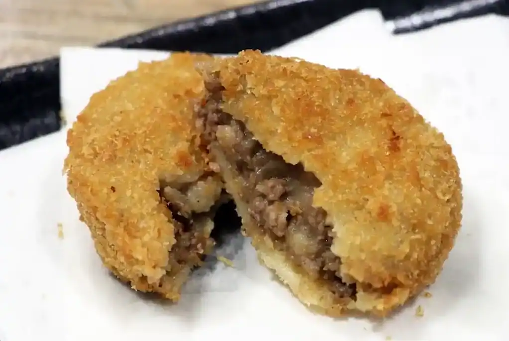 Delicious Kobe beef croquette with crispy golden breading and tender meat filling.