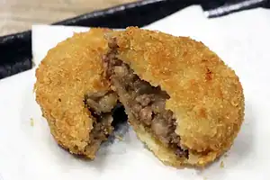 Delicious Kobe beef croquette with crispy golden breading and tender meat filling.