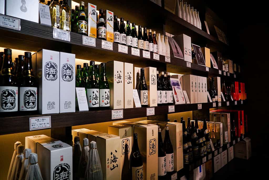 Elegant display of Niigata sake bottles and packaging in a Japanese liquor shop.