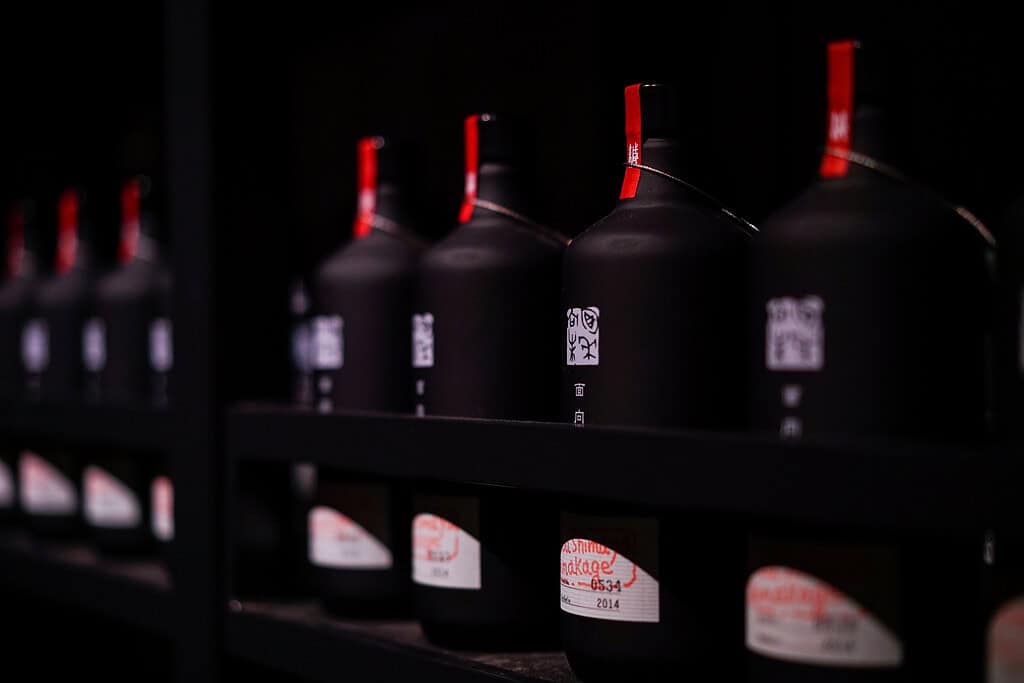 Bottles of Niigata sake displayed on a shelf in Japan.