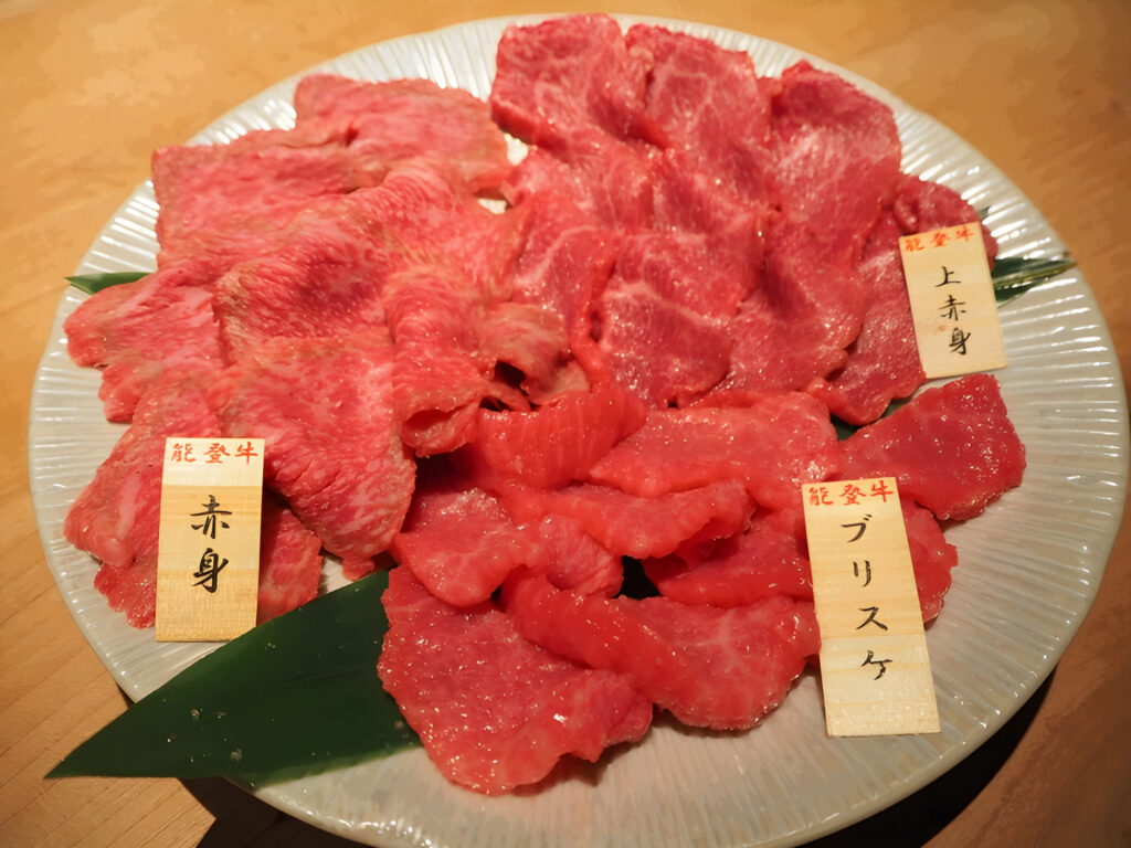 Premium Noto beef slices showcasing marbling and tenderness.