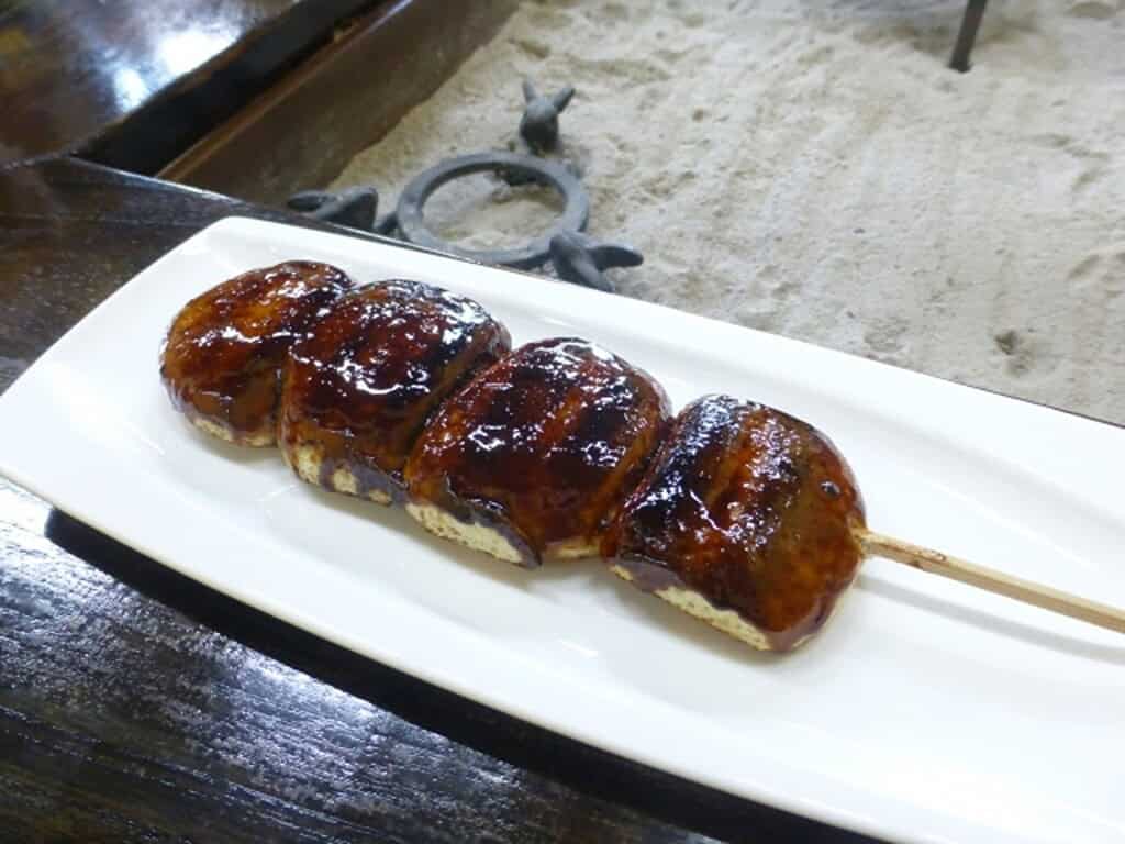 Traditional Yaki Manju skewers with sweet glaze, served in Japan.