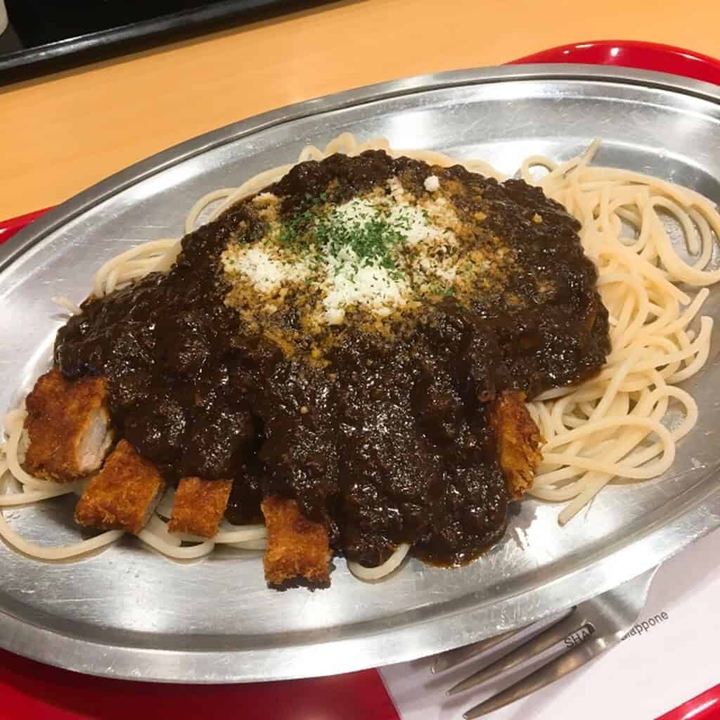 Takasaki Pasta served with savory black sauce and crispy toppings in Japan.
