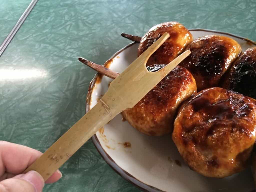 Traditional Yaki Manju grilled sweet buns on skewers in Japan.
