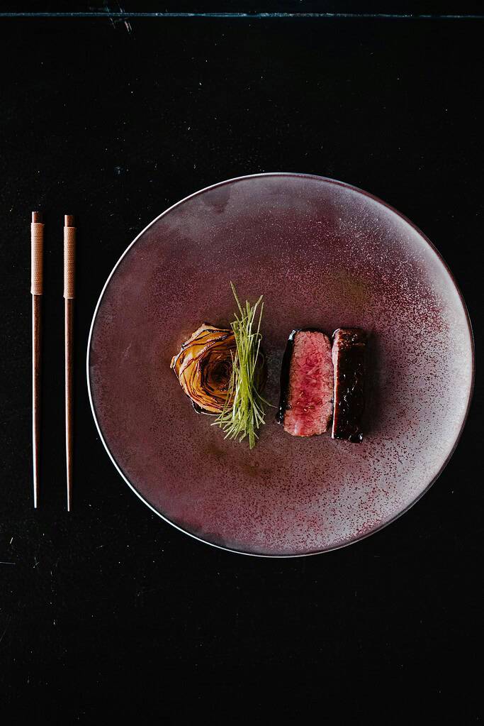 Premium Tajima beef steak served with garnish on a stylish plate in Japan.
