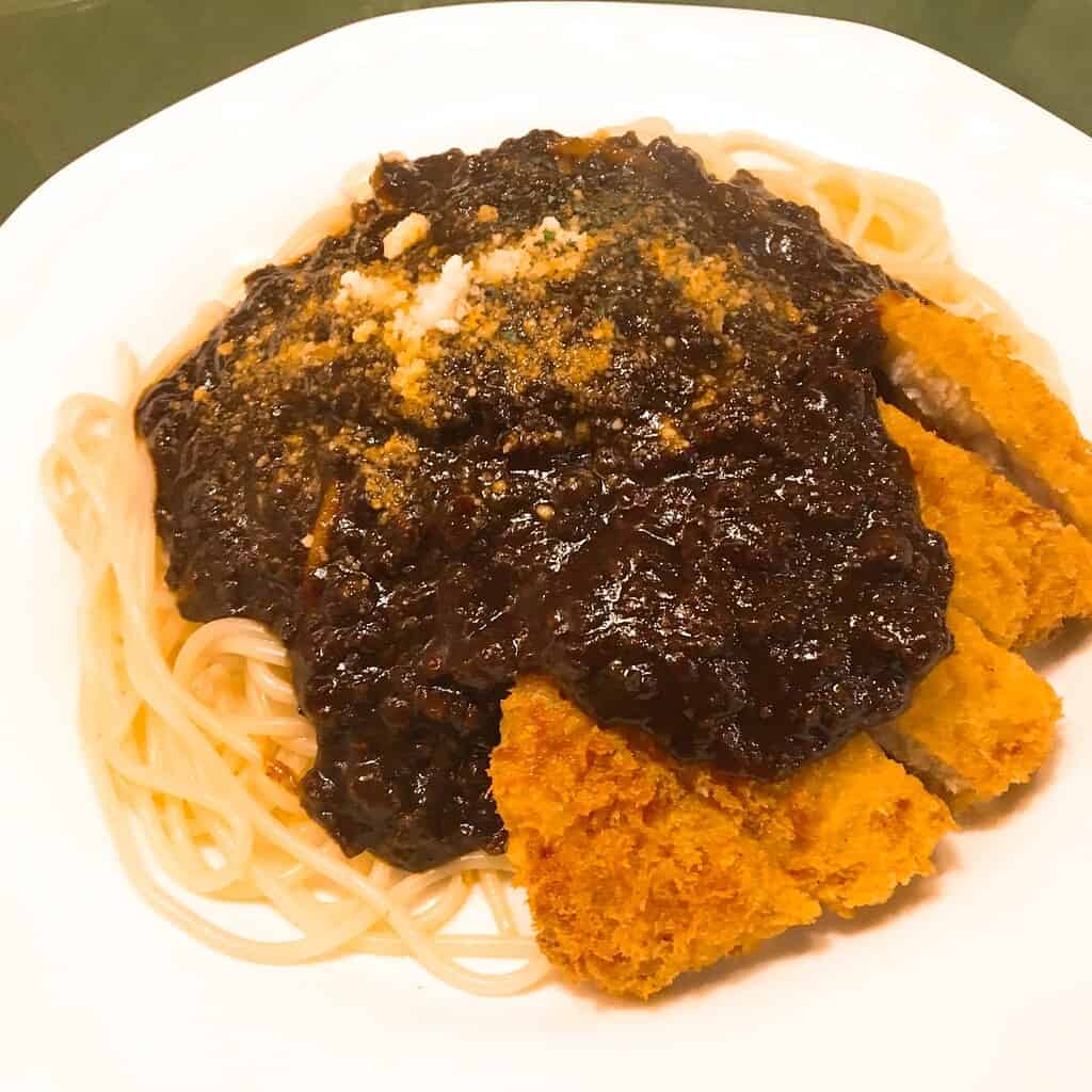 Delicious Takasaki Pasta featuring crispy fried cutlet topped with rich Japanese-style sauce, served.