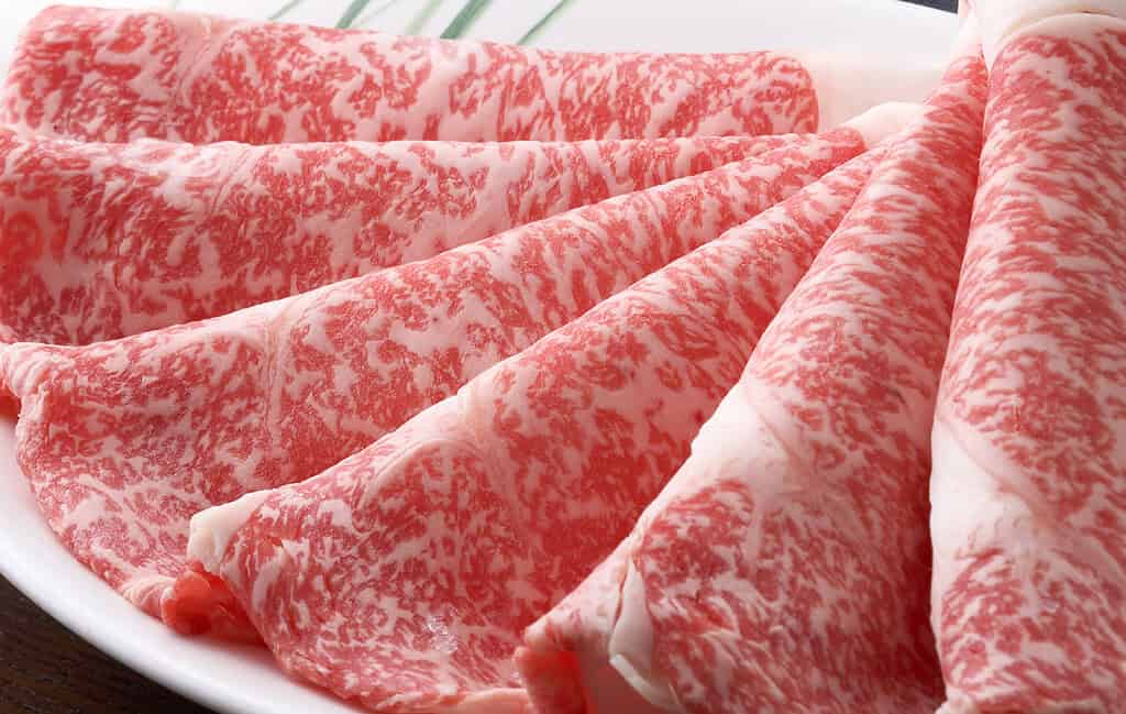 Premium Maesawa Beef slices with rich marbling, perfect for Japanese cuisine.