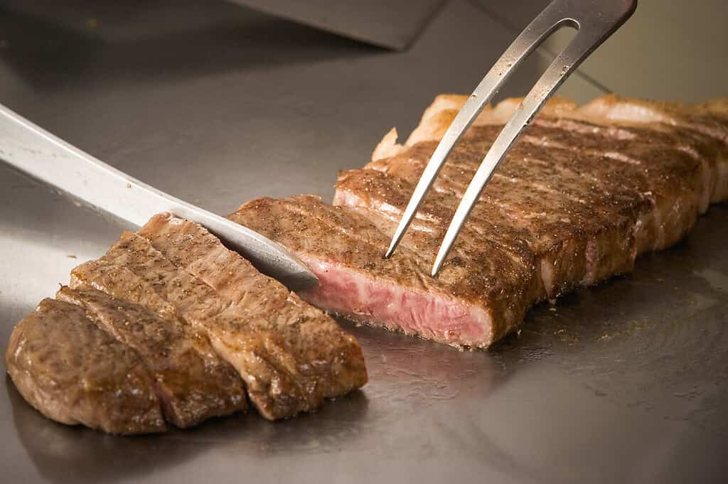 Premium Maesawa Beef steak being sliced, showcasing high-quality Japanese Wagyu.