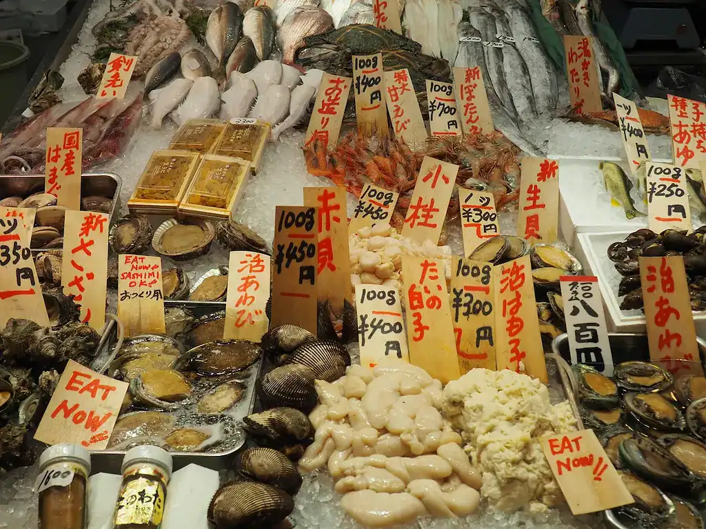 Seafood in Japan market with clams, oysters, and shellfish, showcasing fresh catch and traditional p.
