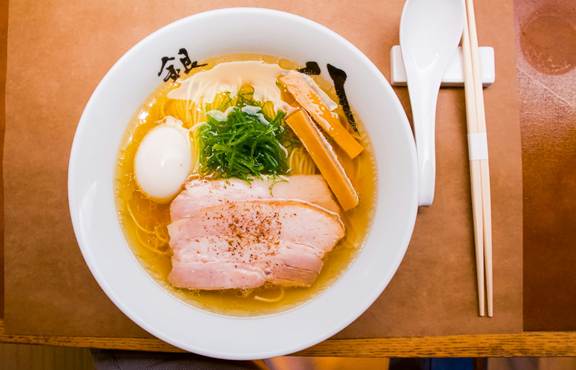 Traditional Japanese ramen with pork, egg, green onions, and bamboo shoots.