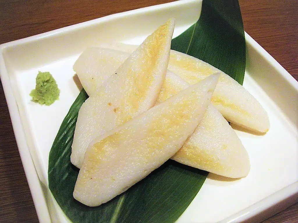 Sasa Kamaboko slices served with wasabi on a white dish.
