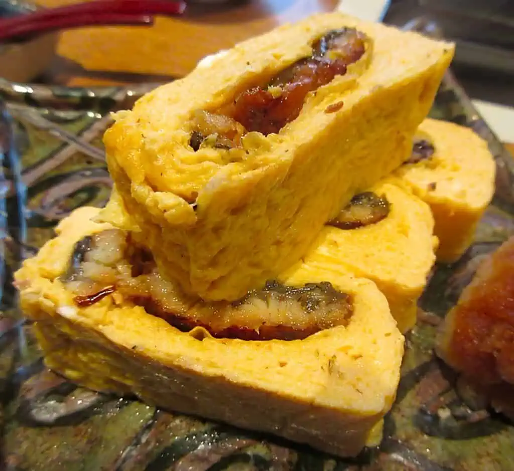 Tamagoyaki with eel filling, a traditional Japanese rolled omelette dish.