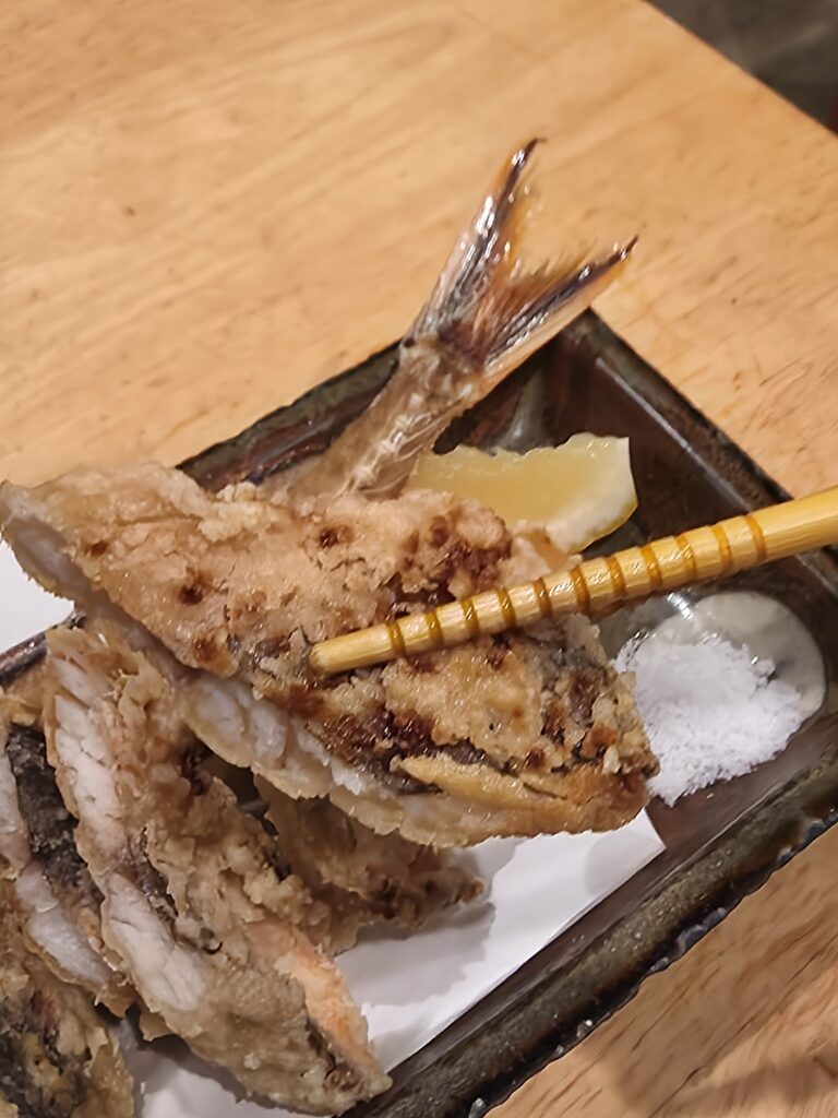 Fried gurukun fish with lemon and salt, traditional Japanese dish.