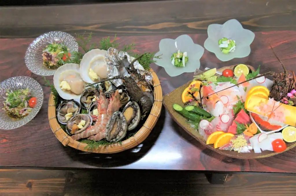 Fresh seafood platter with oysters, shrimp, and sashimi for Japanese cuisine.