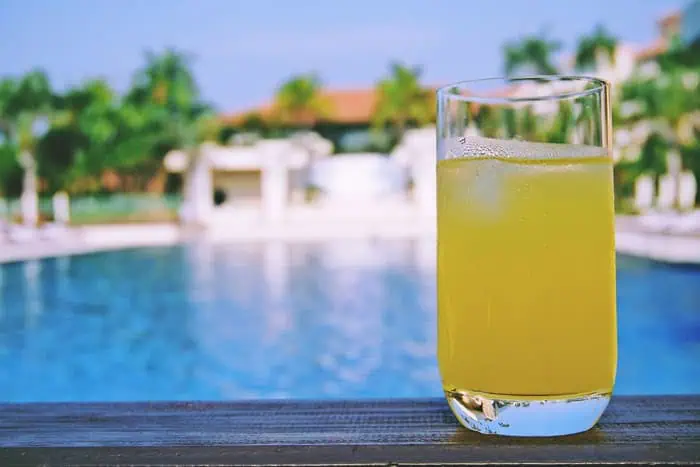 Refreshing Shikuwasa drink in a glass with poolside background.