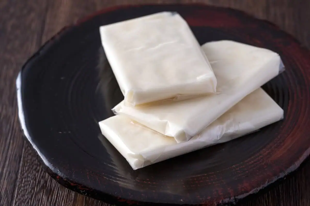 Broken pieces of amegata on a dark plate showing the airy pale inside